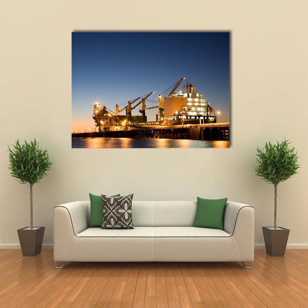 Illuminated Cargo Ship at Night Canvas Wall Art in black, yellow and blue, single panel hung on a wall