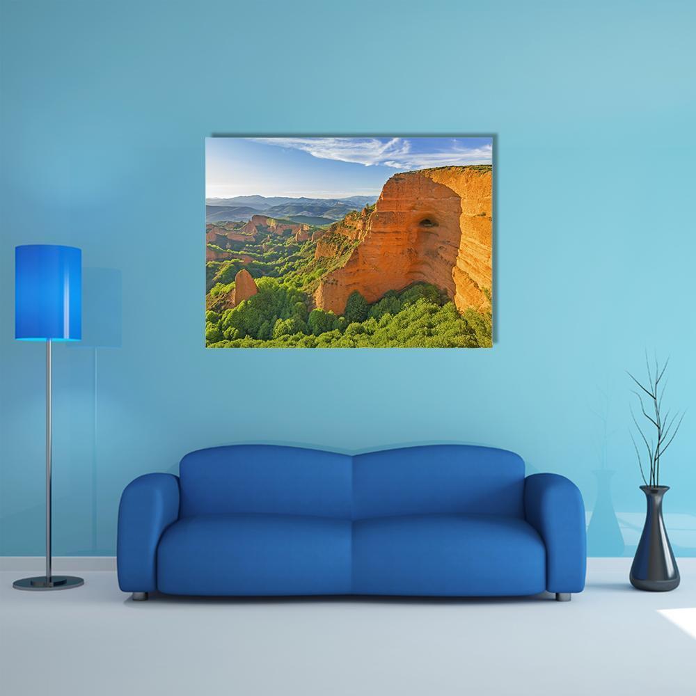 Sunlit Canyon Landscape with Trees Canvas Wall Art in orange, green and blue, single panel hung on a wall