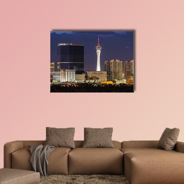 Las Vegas Night Skyline with Stratosphere Tower Canvas Wall Art in black, yellow and blue, single panel hung on a wall