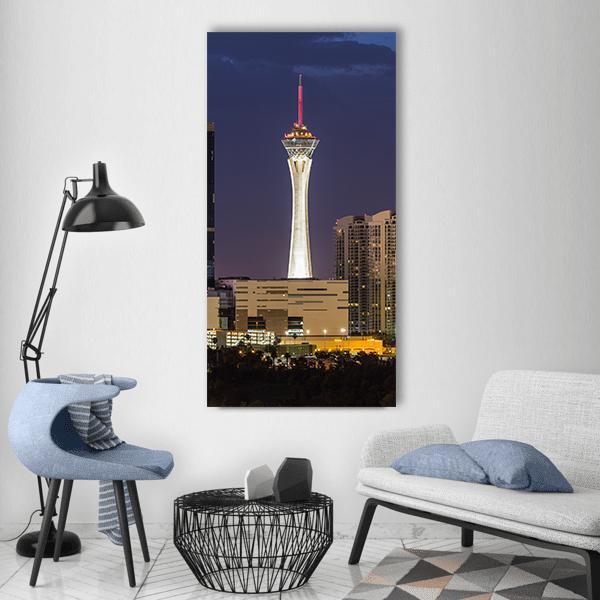 Las Vegas Skyline with the Strat Tower Vertical Canvas Wall Art in yellow, blue and purple, single vertical panel hung on a wall