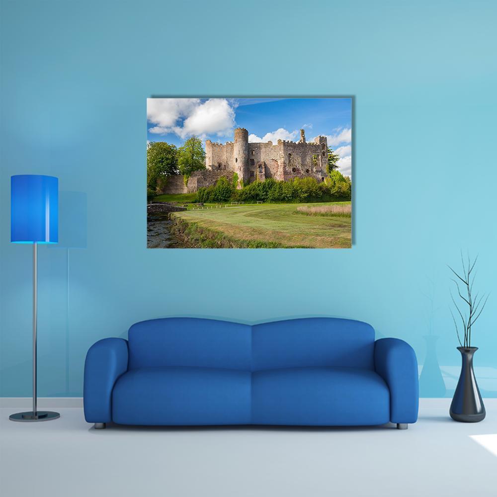 Laugharne Castle Ruins Over River Canvas Wall Art in brown, green and blue, single panel hung on a wall