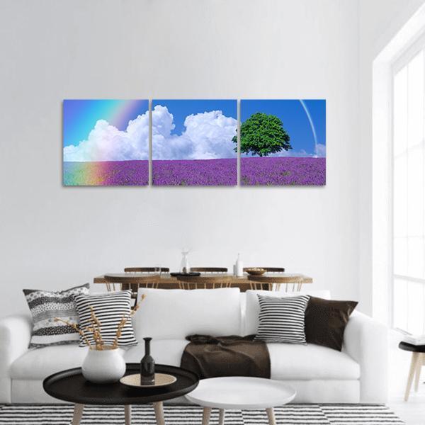 Lavender Field with Lone Tree and Rainbow Panoramic Canvas Wall Art in green, blue and purple, hung on a wall