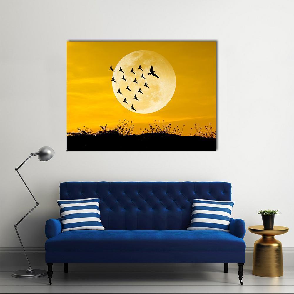 Moon and Birds Silhouettes Canvas Wall Art in black, white and yellow, single panel hung on a wall