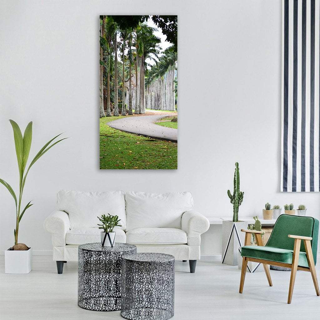 Winding Paved Path with Palm Trees Vertical Canvas Wall Art in white, gray and green, single vertical panel hung on a wall