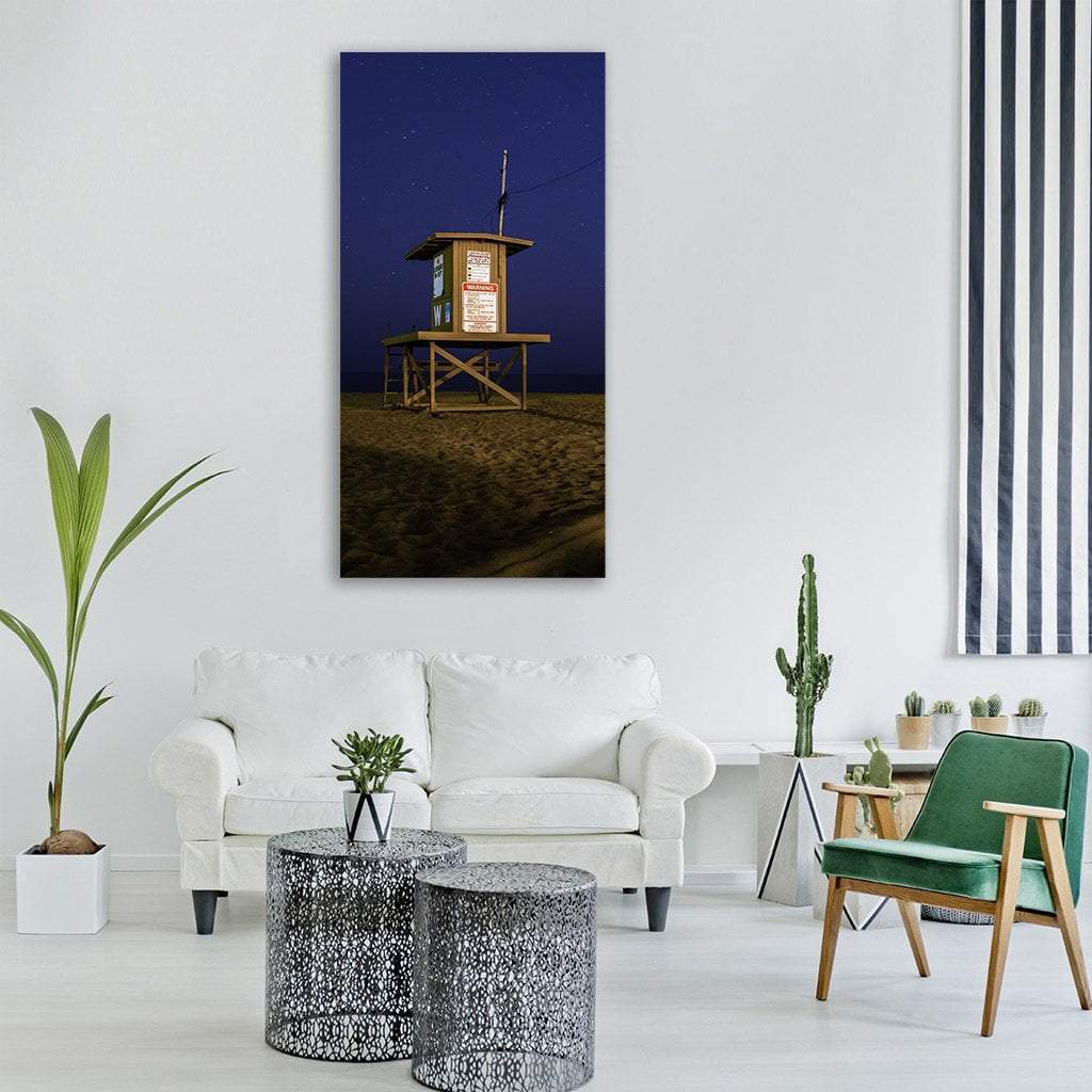 Lifeguard Tower on Sandy Beach Vertical Canvas Wall Art in brown, blue and navy, single vertical panel hung on a wall