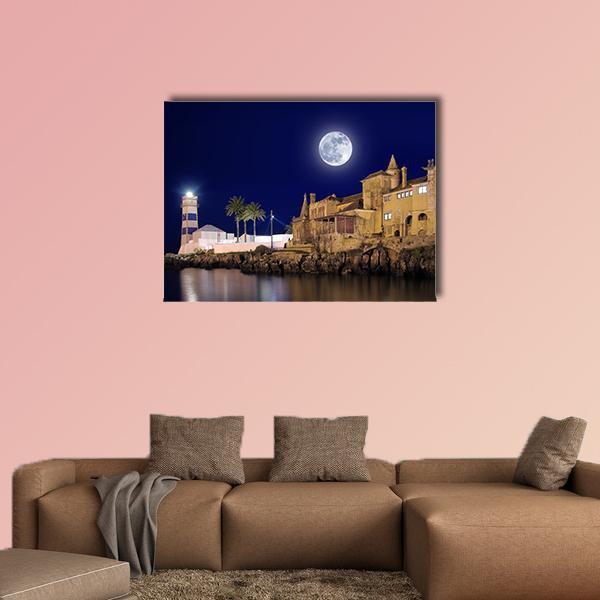 Moonlit Lighthouse and Coastal House Canvas Wall Art in brown, blue and navy, single panel hung on a wall