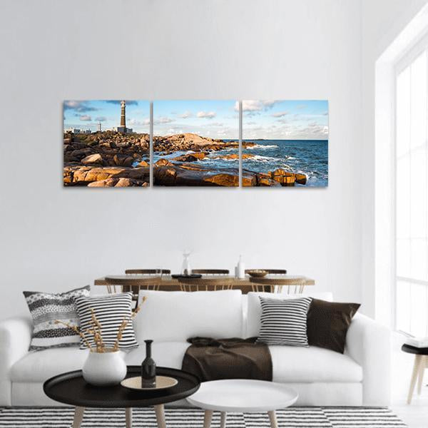 Cabo Polonio Lighthouse Panoramic Canvas Wall Art in white, brown and blue, hung on a wall
