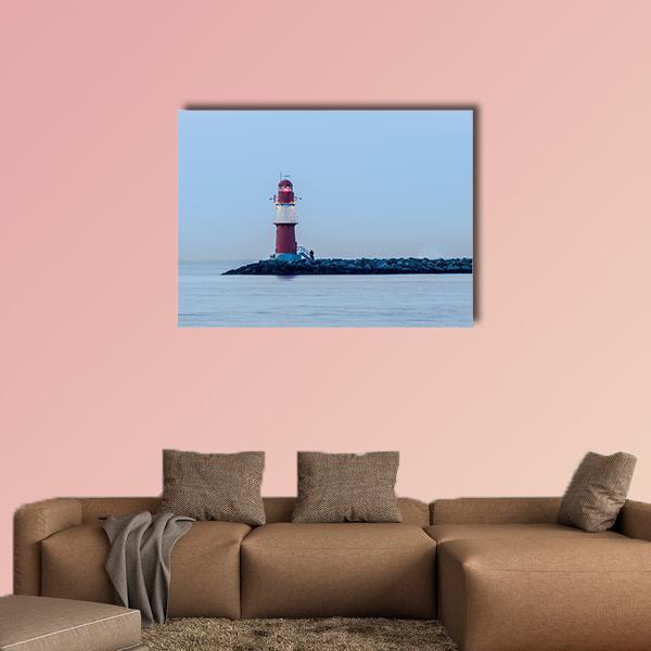 Red and White Lighthouse on Rocky Pier Canvas Wall Art in white, red and blue, single panel hung on a wall