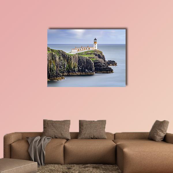 White Lighthouse on Sheer Cliffs Canvas Wall Art in white, gray and blue, single panel hung on a wall