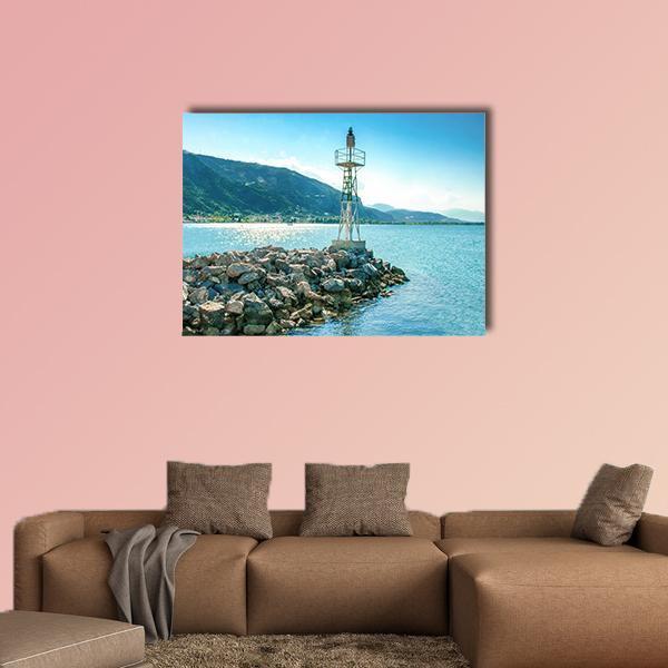 Lighthouse on Rocky Breakwater Greece Canvas Wall Art in gray and blue, single panel hung on a wall