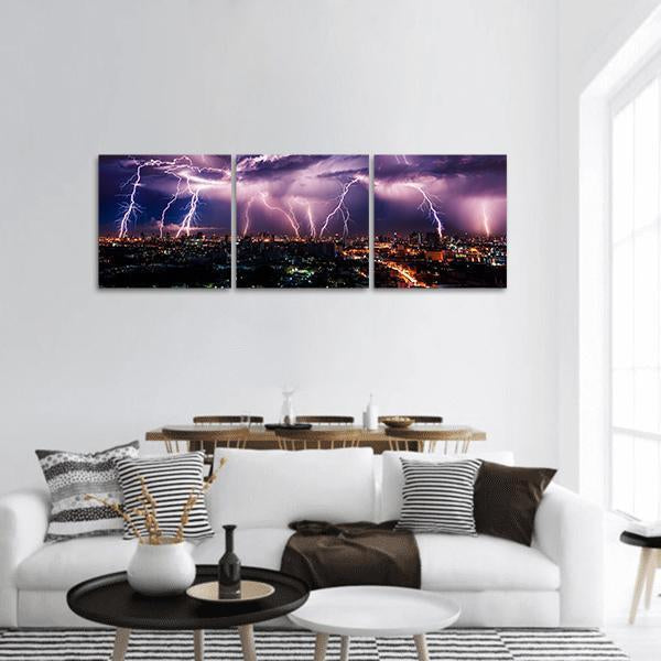 Purple Lightning Over City Panoramic Canvas Wall Art in black, blue and purple, hung on a wall