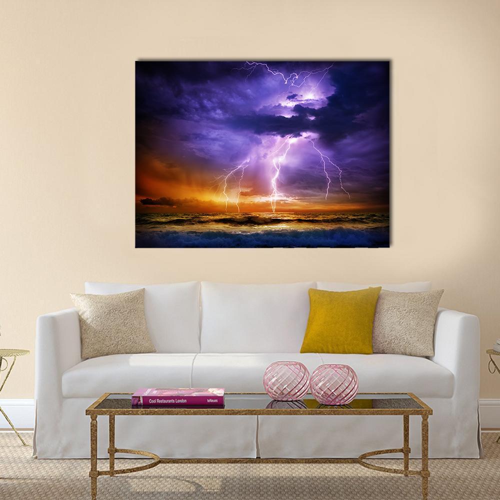 Dramatic Lightning Over Stormy Ocean Canvas Wall Art in orange, blue and purple, single panel hung on a wall