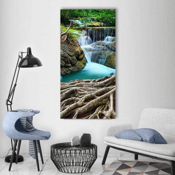 Limestone Waterfalls with Tree Roots Vertical Canvas Wall Art in brown, green and blue, single vertical panel hung on a wall