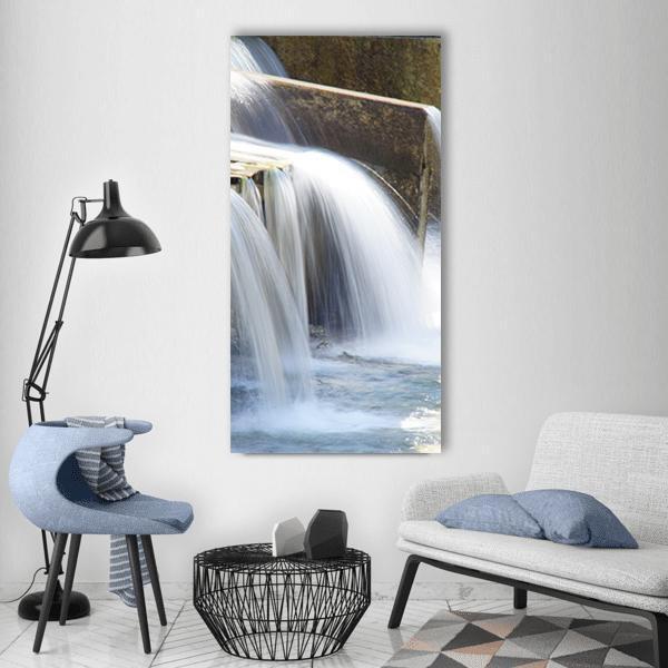 Concrete Dam Waterfall Long Exposure Vertical Canvas Wall Art in white, gray and blue, single vertical panel hung on a wall
