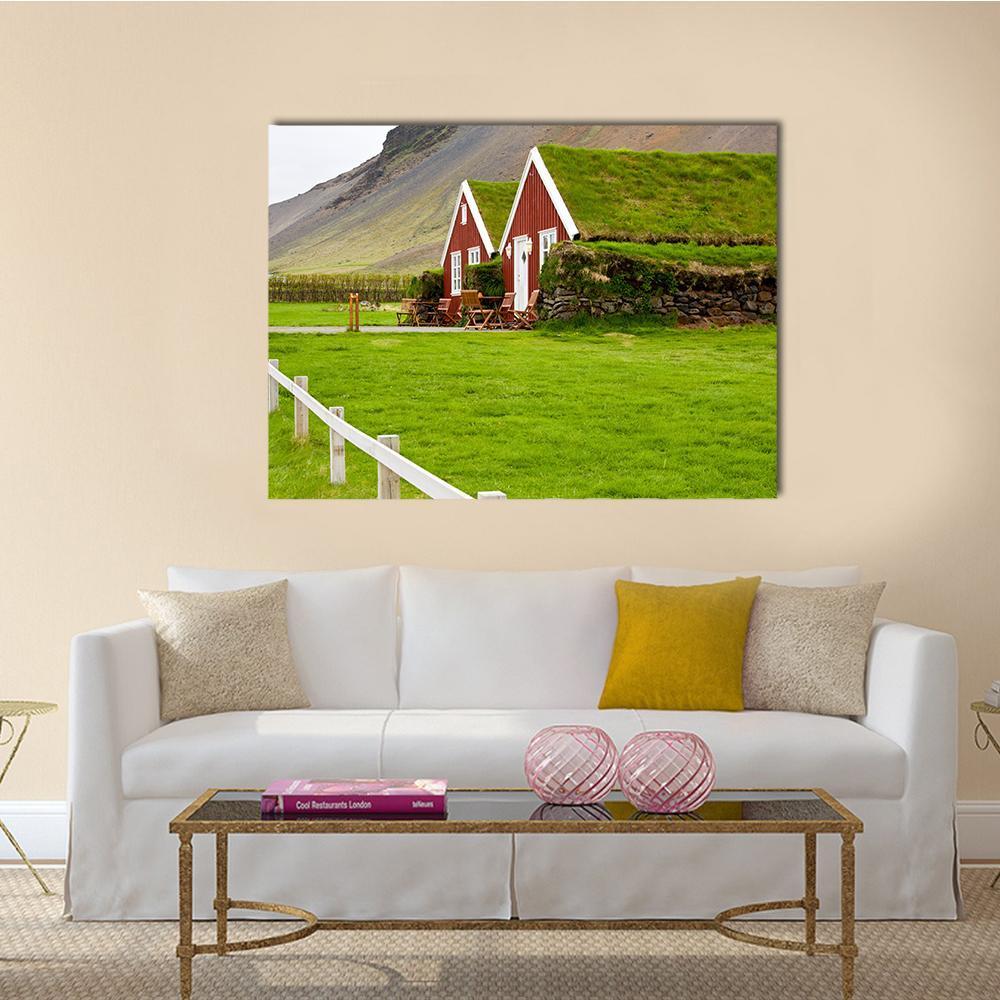 Iceland Turf Houses on Green Hillside Canvas Wall Art in gray, red and green, single panel hung on a wall