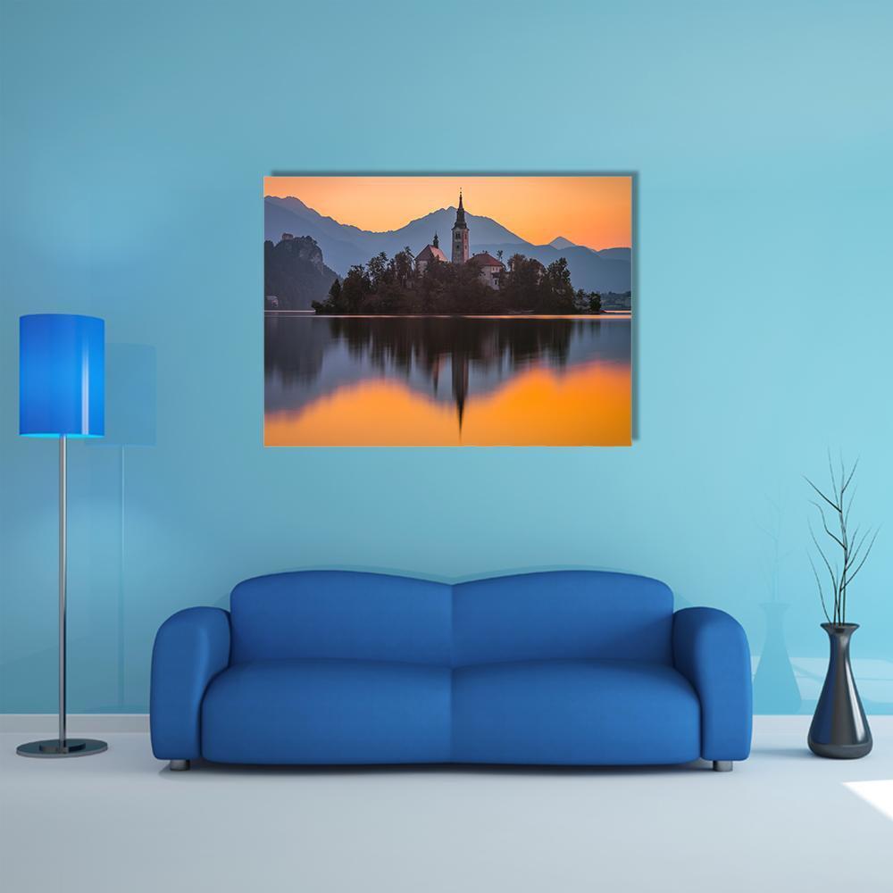 Island Church at Sunset Canvas Wall Art in black, orange and blue, single panel hung on a wall