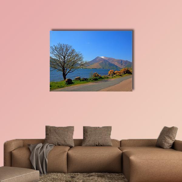 Loch Leven Lakeshore with Snow-capped Peak Canvas Wall Art in brown, green and blue, single panel hung on a wall