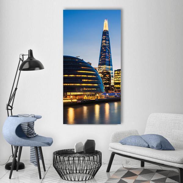 London Night Skyline Over the Thames Vertical Canvas Wall Art in black, gold and blue, single vertical panel hung on a wall