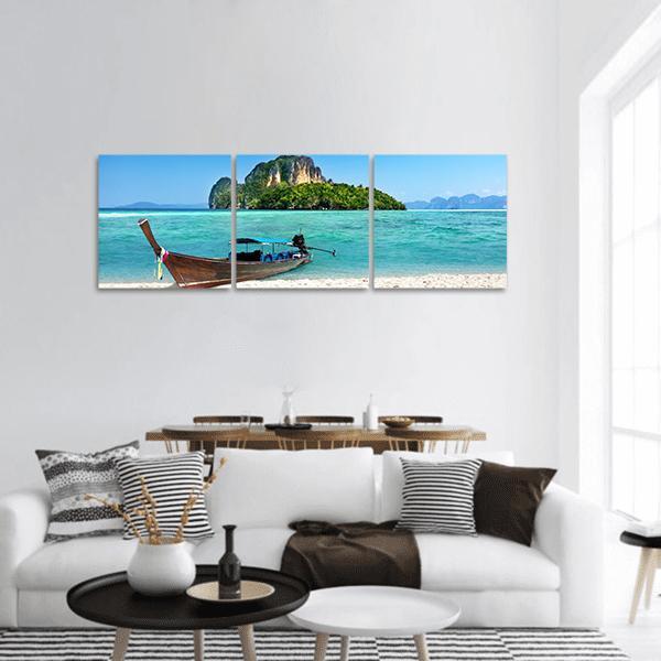 Longtail Boat on Turquoise Beach Panoramic Canvas Wall Art in white, green and blue, hung on a wall