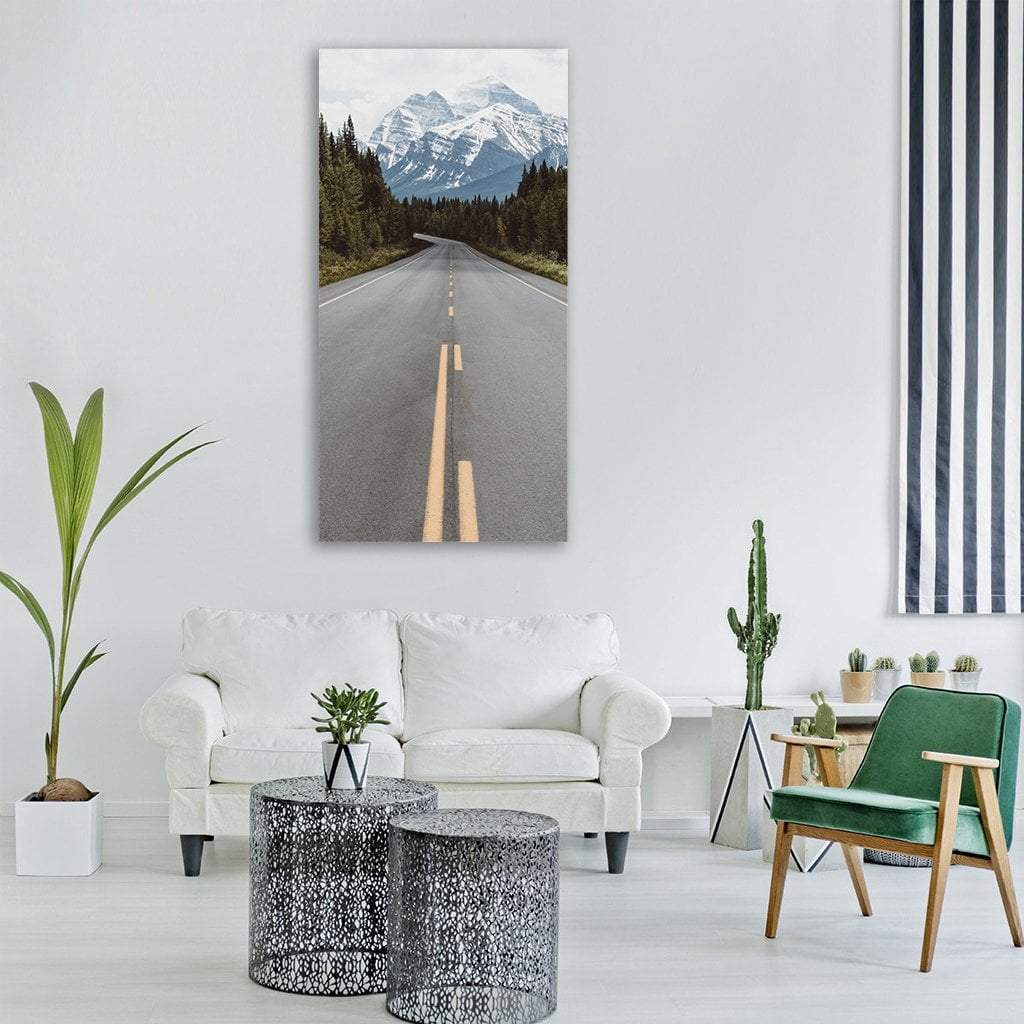 Highway Through Mountain Wilderness Vertical Canvas Wall Art in white, gray and green, single vertical panel hung on a wall