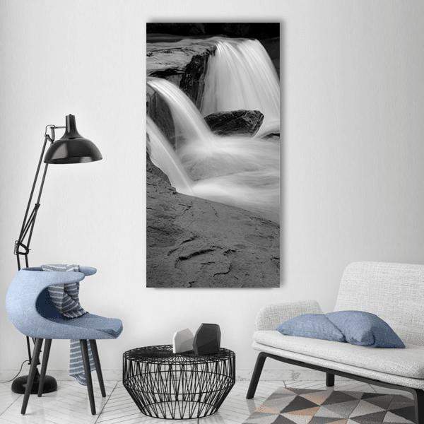 Long Exposure Waterfall Vertical Canvas Wall Art in black, white and gray, single vertical panel hung on a wall
