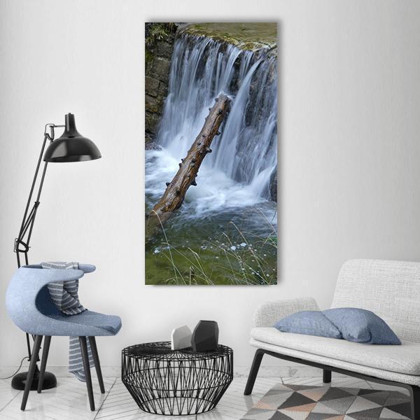 Fallen Tree Trunk in Waterfall Vertical Canvas Wall Art in white, gray and green, single vertical panel hung on a wall