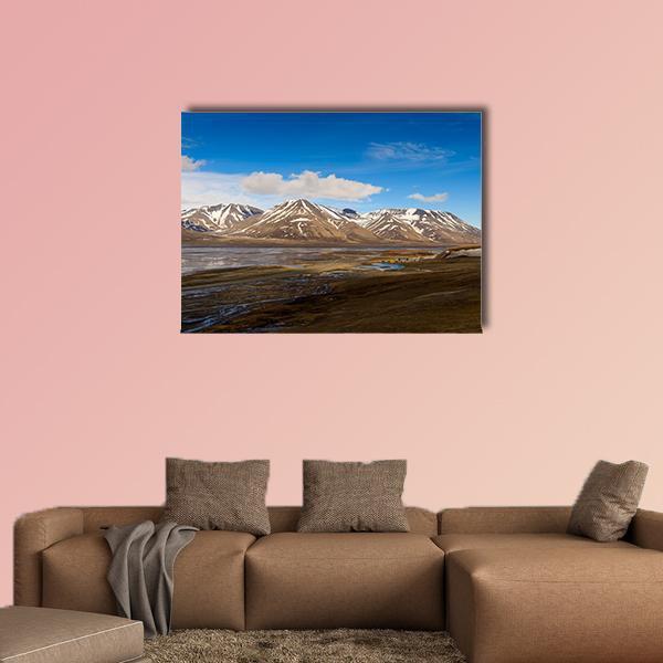 Svalbard Snow-capped Mountains and Winding River Canvas Wall Art in white, brown and blue, single panel hung on a wall