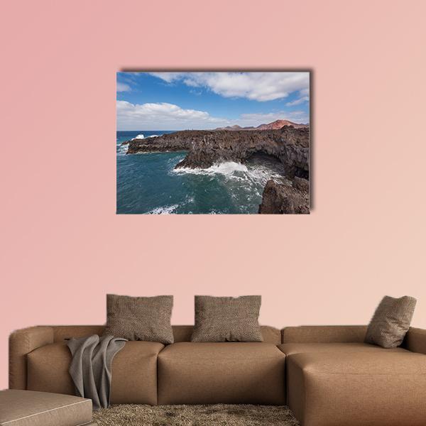 Los Hervideros Coastline Canvas Wall Art in black, white and blue, single panel hung on a wall