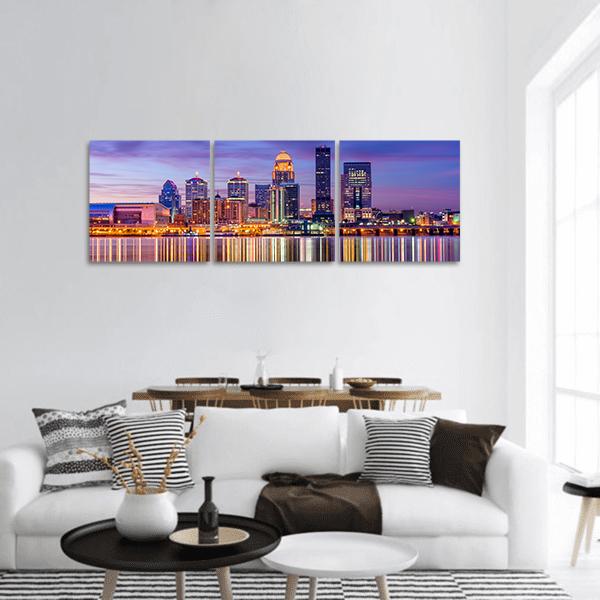 Louisville Skyline with River Reflections Panoramic Canvas Wall Art in orange, blue and purple, hung on a wall