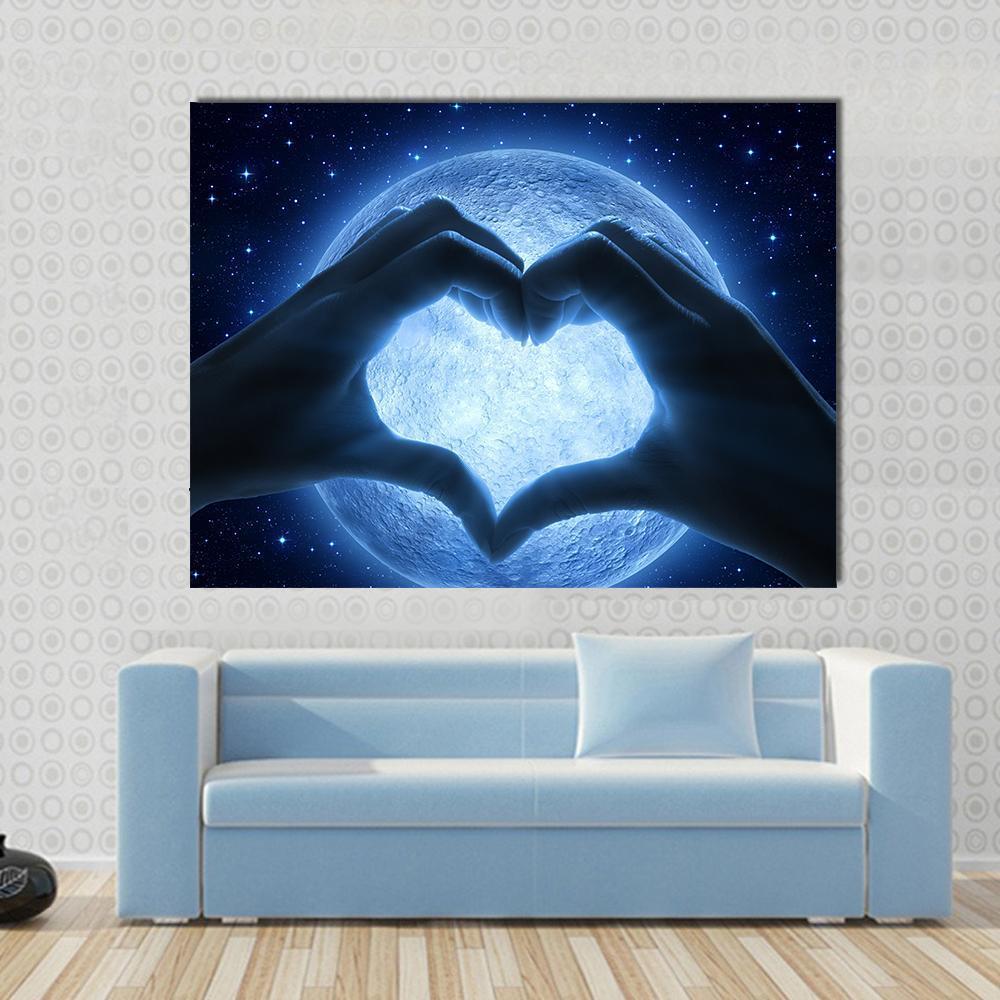 Hands Heart Moon Canvas Wall Art in black and blue, single panel hung on a wall