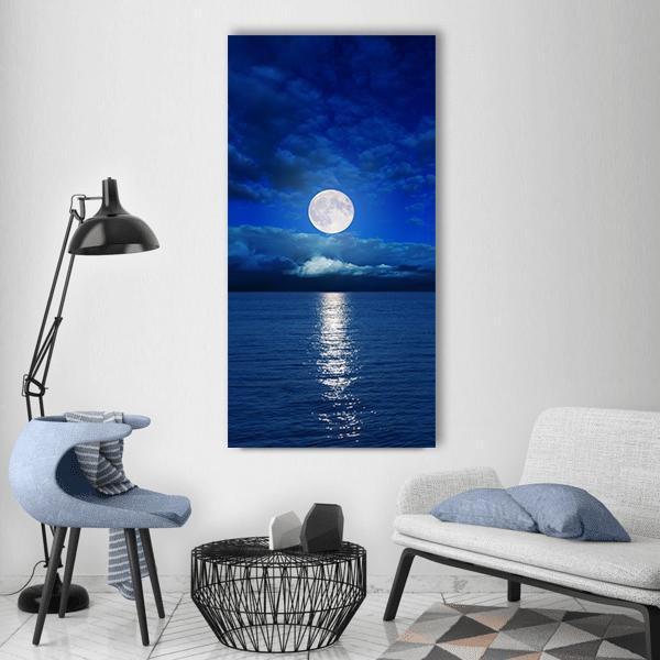 Low Moon Over River Vertical Canvas Wall Art in white, blue and navy, single vertical panel hung on a wall