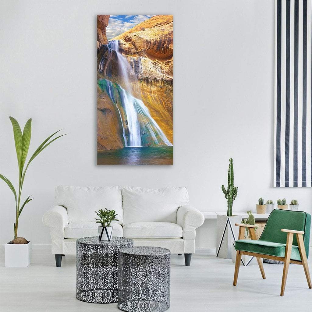 Lower Calf Creek Falls Vertical Canvas Wall Art in brown, orange and blue, single vertical panel hung on a wall