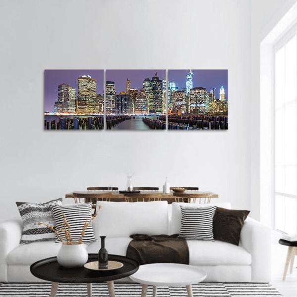 Lower Manhattan Skyline Panoramic Canvas Wall Art in black, yellow and purple, hung on a wall