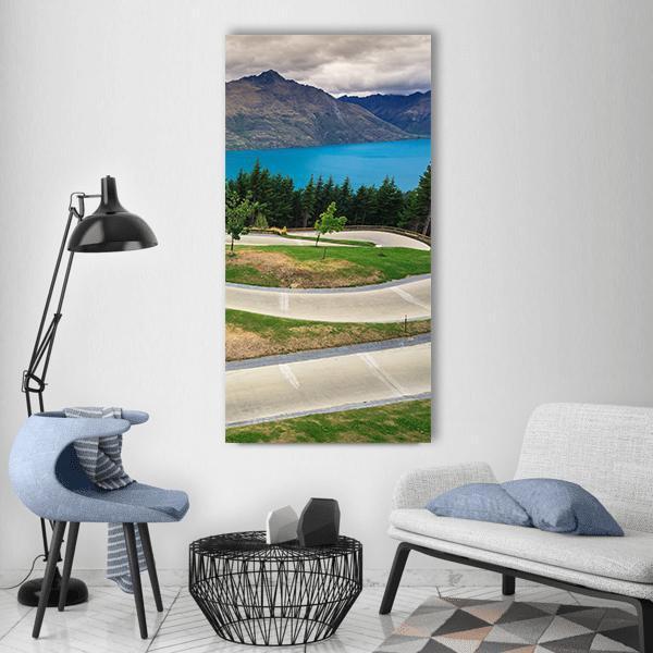 Queenstown Skyline Luge Road Over Turquoise Lake Vertical Canvas Wall Art in gray, green and blue, single vertical panel hung on a wall