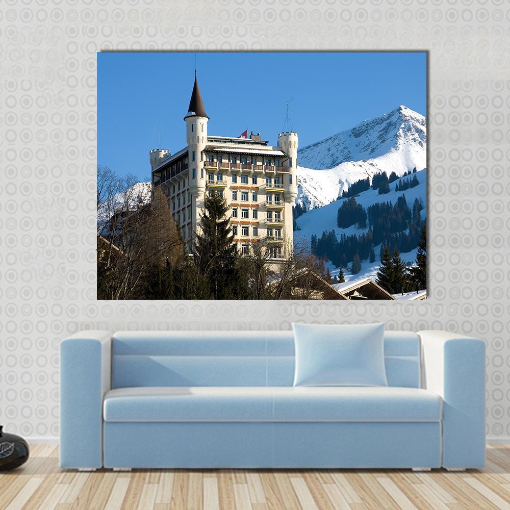 Gstaad Castle-like Hotel with Mountain Peak Canvas Wall Art in white, beige and blue, single panel hung on a wall