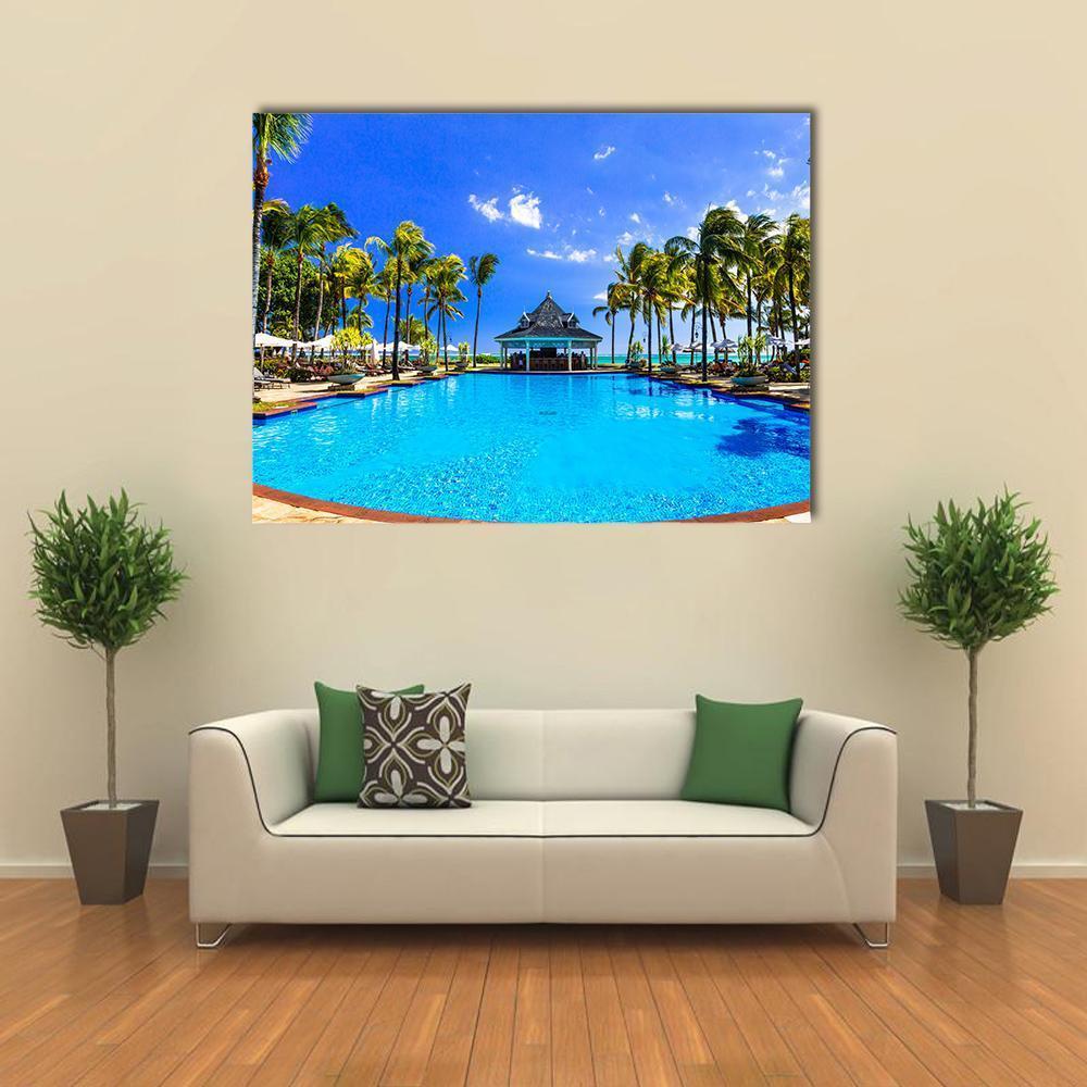 Mauritius Resort Pool with Palm Trees Canvas Wall Art in green and blue, single panel hung on a wall