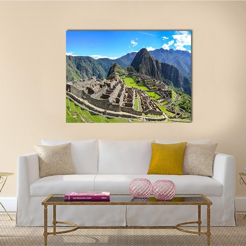 Machu Picchu Ancient Ruins Canvas Wall Art in gray, green and blue, single panel hung on a wall