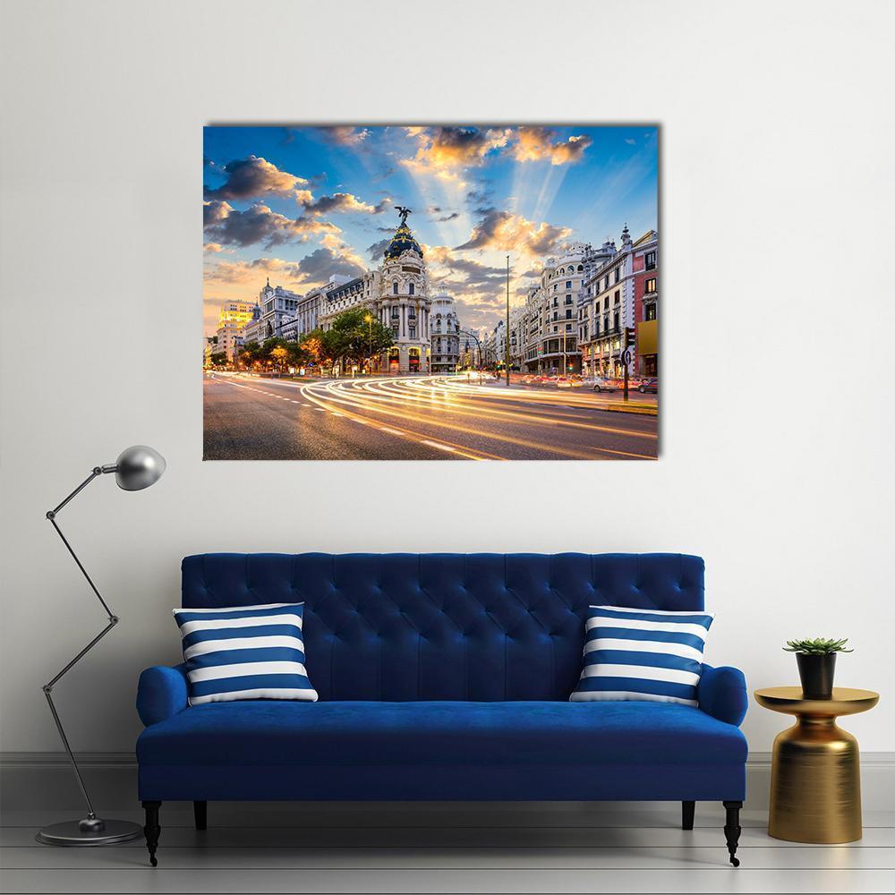 Dusk City Street with Light Trails Canvas Wall Art in orange, yellow and blue, single panel hung on a wall
