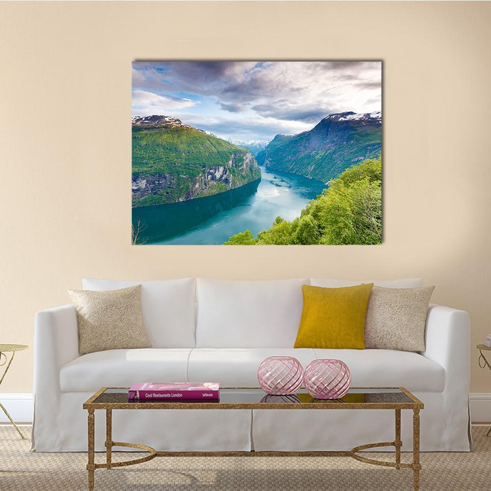 Geiranger Fjorden Valley with Snow-capped Peaks Canvas Wall Art in white, green and blue, single panel hung on a wall