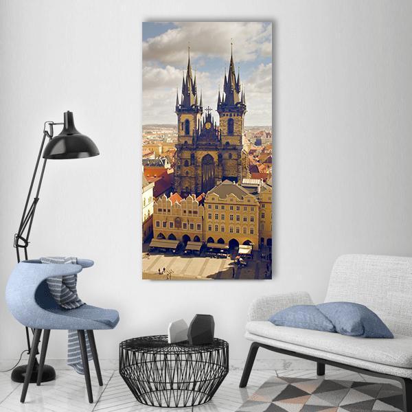 Prague Old Town Square with Týn Church Vertical Canvas Wall Art in beige, yellow and blue, single vertical panel hung on a wall