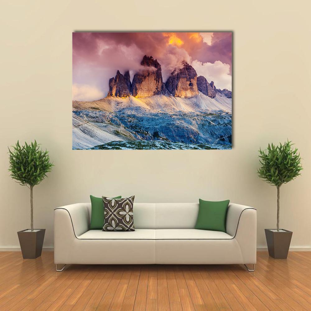 Foggy Mountain Rifugio at Sunset Canvas Wall Art in orange, blue and purple, single panel hung on a wall