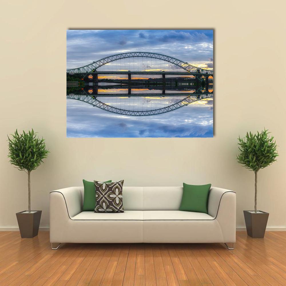 Arched River Bridge at Twilight Canvas Wall Art in gray, yellow and blue, single panel hung on a wall