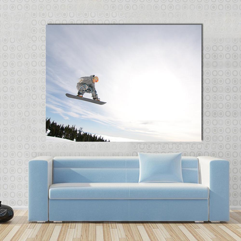 Snowboarder in Air Canvas Wall Art in white and blue, single panel hung on a wall