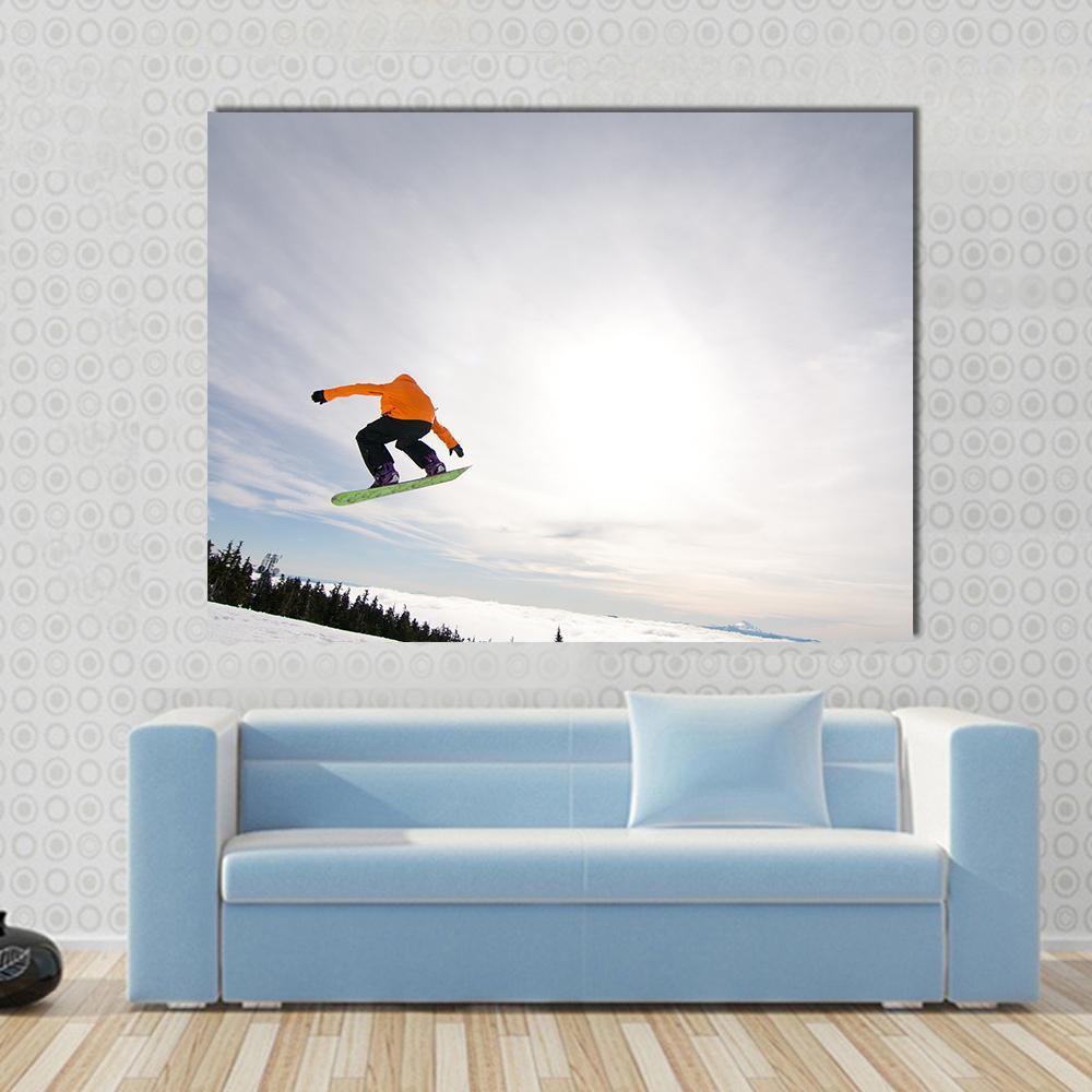 Snowboarder Mid-air in Orange Jacket Canvas Wall Art in white, orange and blue, single panel hung on a wall