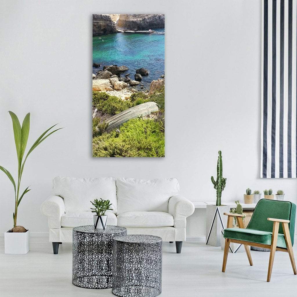 Malta Cove with Weathered Wooden Boat Vertical Canvas Wall Art in brown, green and blue, single vertical panel hung on a wall