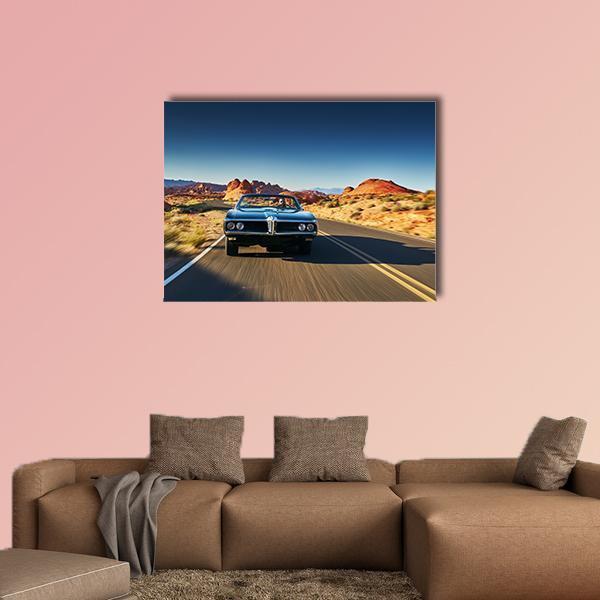 Vintage Blue Convertible on Desert Road Canvas Wall Art in brown, orange and blue, single panel hung on a wall