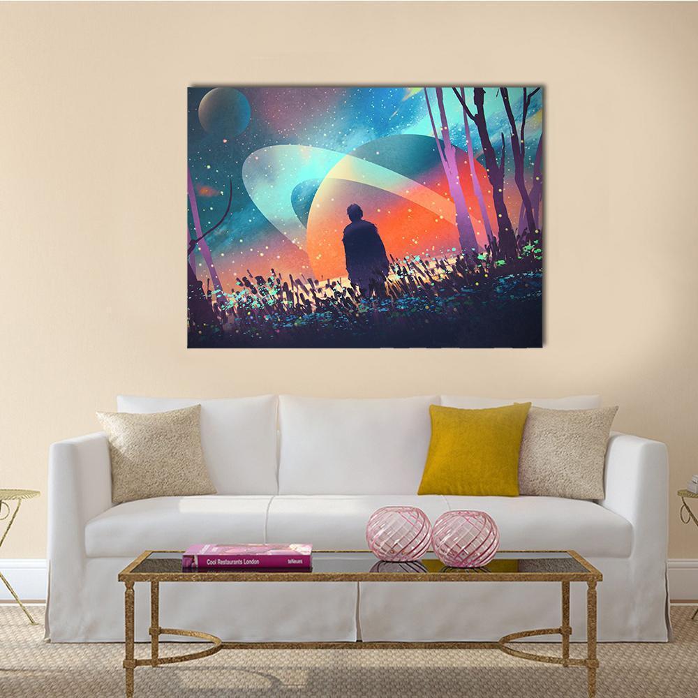 Silhouette Man on Ringed Alien Planet Canvas Wall Art in orange, blue and purple, single panel hung on a wall