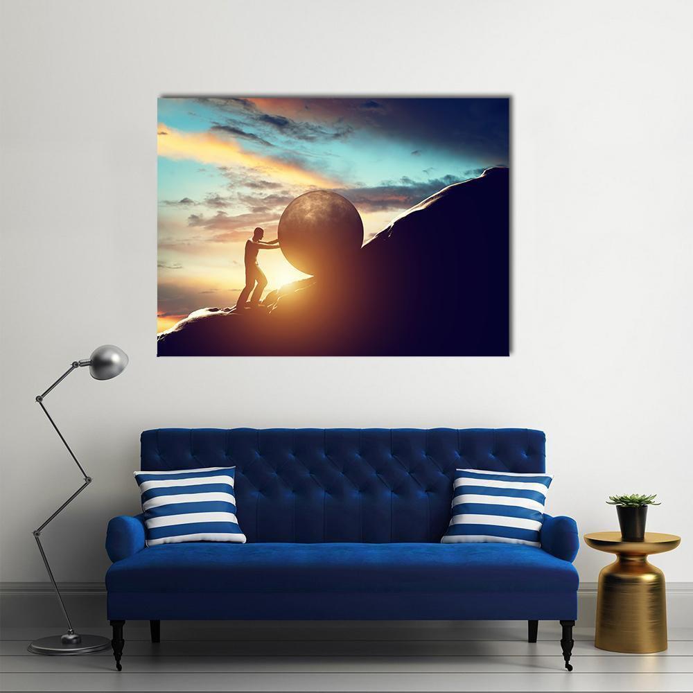 Man Pushing Boulder at Sunset Canvas Wall Art in black, orange and blue, single panel hung on a wall