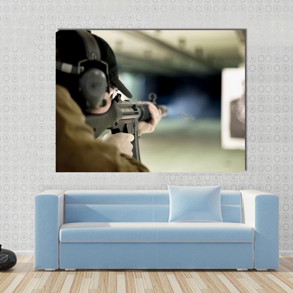 Man Shooting Target Canvas Wall Art in black, gray and brown, single panel hung on a wall