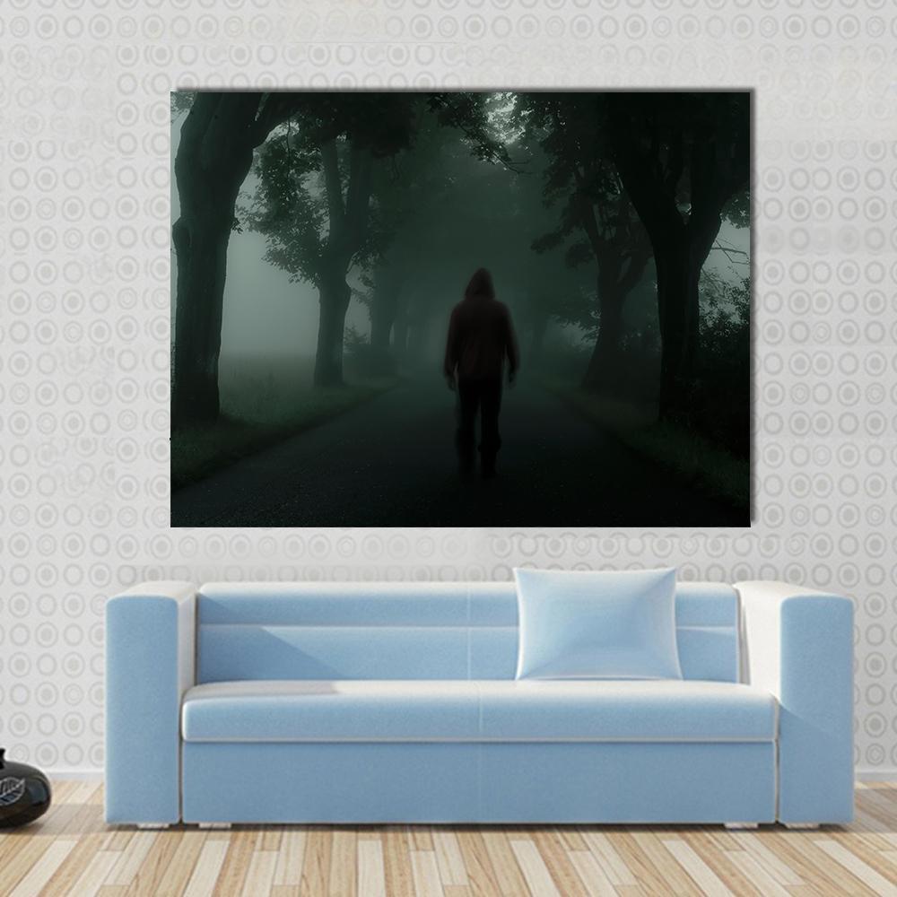 Man Silhouette in Dark Forest Canvas Wall Art in black, gray and green, single panel hung on a wall